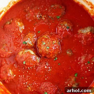 Perfectly baked Italian meatballs nestled in rich marinara sauce.