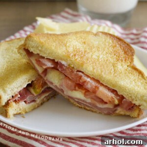 Fried Bologna Sandwich with Melted Provolone Cheese and Fresh Tomato on Toasted Bread on a Plate