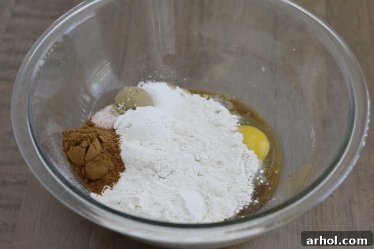 All pancake ingredients mixed together in one mixing bowl, showing a thick, ready-to-cook batter.