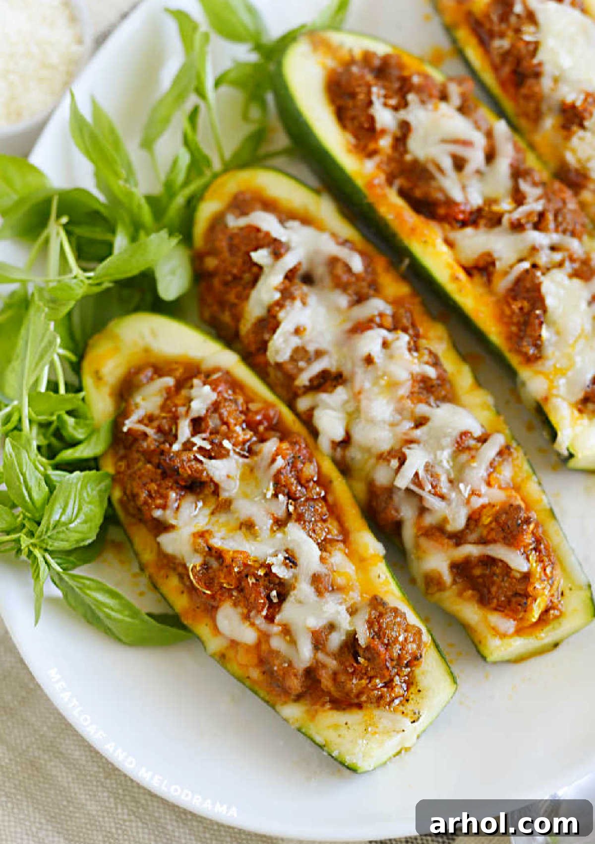 Delicious low carb stuffed zucchini boats with Italian sausage and melted cheese, ready to serve.