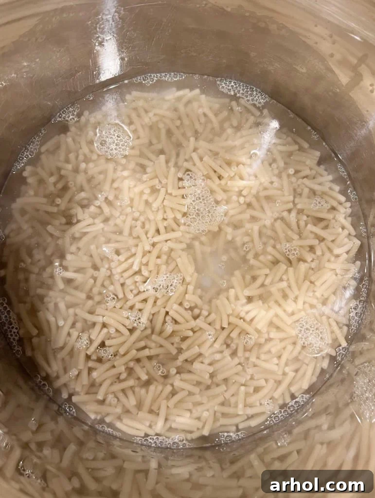 Creamy Instant Pot Kraft Mac and Cheese 4 Two boxes of Kraft Mac and Cheese macaroni noodles added to the Instant Pot with water.