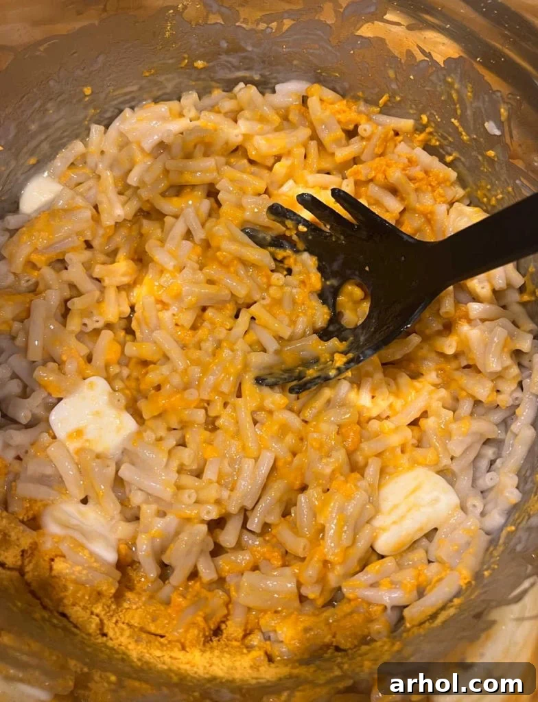Creamy Instant Pot Kraft Mac and Cheese 5 Mixing the cheese powder and butter with the cooked macaroni in the Instant Pot.