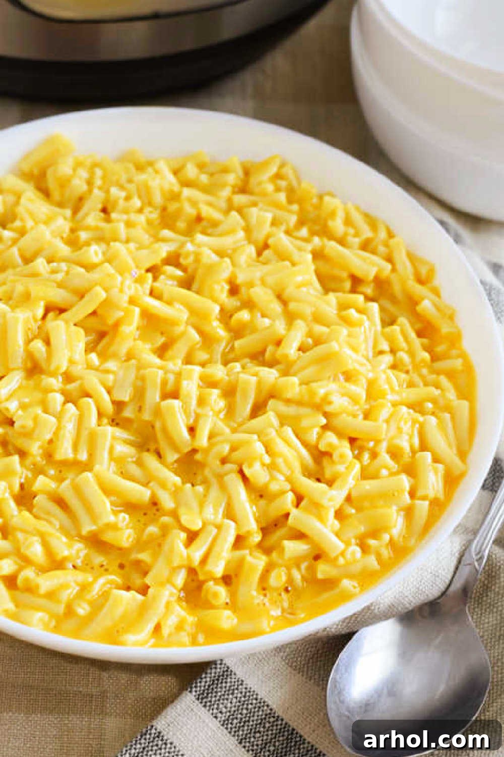 Creamy Instant Pot Kraft Mac and Cheese 9 Close up of a serving of Instant Pot boxed mac and cheese in a white bowl, showing its rich and smooth texture.