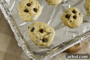 Freshly baked cake mix banana cookies on a baking sheet, with golden brown edges.