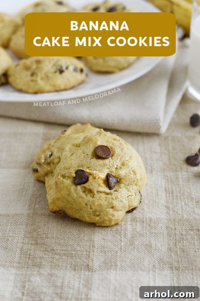 close up of a single cake mix banana cookie with visible chocolate chips on a wooden surface, highlighting its soft texture.