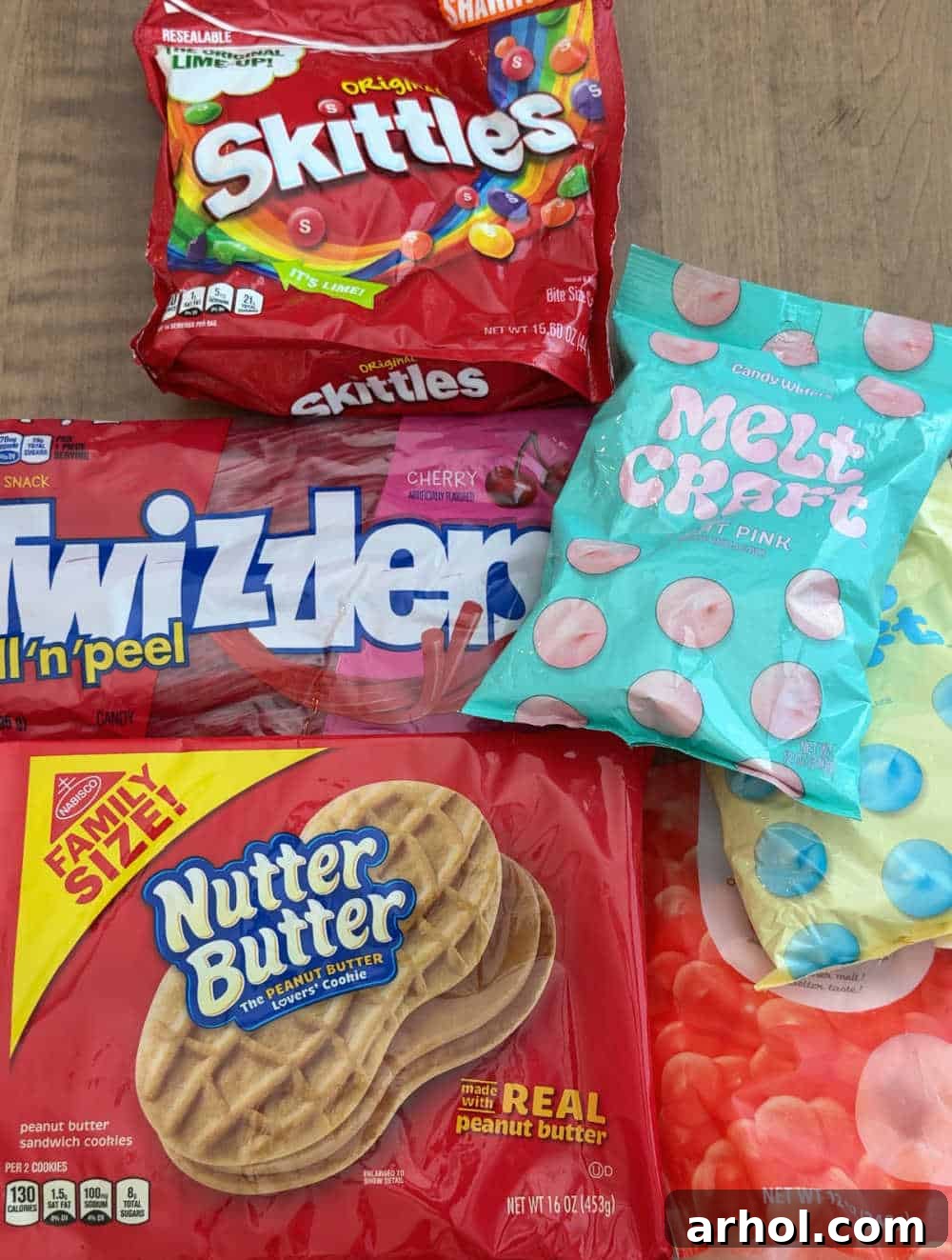 skittles, twizzlers, candy melts, nutter butter package ready for making flip flop cookies.