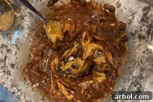 melted peanut butter and chocolate chips in a mixing bowl