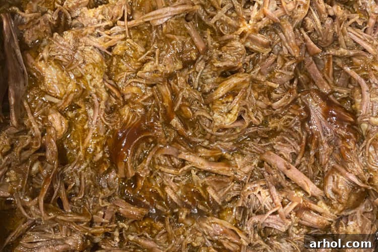 Perfectly shredded beef coated in barbecue sauce, ready to be served from the Instant Pot.