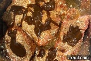 Barbecue sauce over chuck roast chunks in pressure cooker