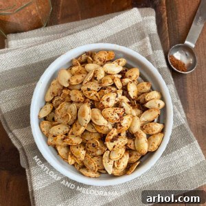 Bowl of spicy roasted pumpkin seeds with taco seasoning, ready to eat.