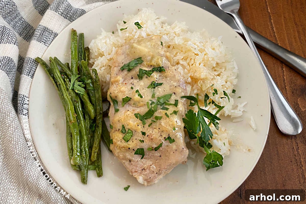 boneless crock pot pork chop on plate with green beans and rice