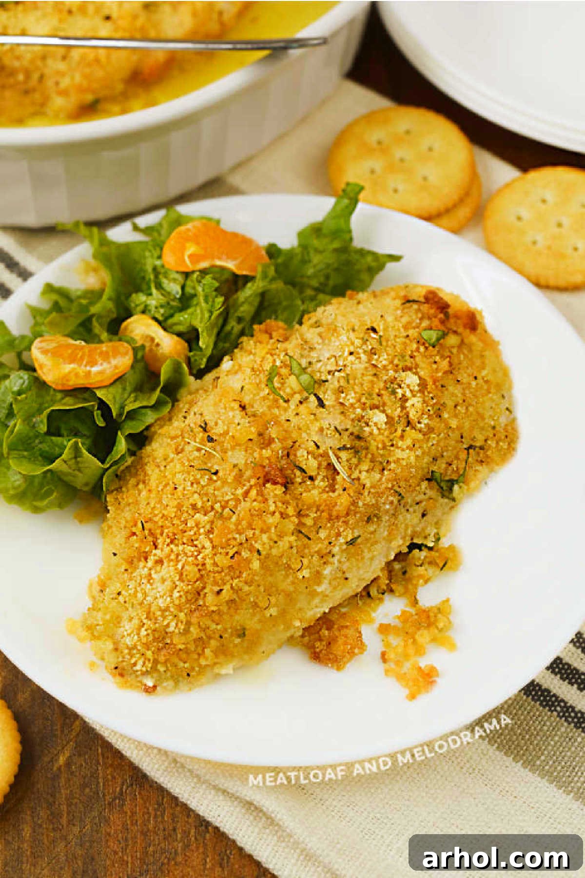 Golden-brown Ritz Cracker Chicken on a white plate, coated with buttery cracker crumbs