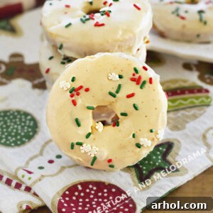Delicious eggnog donuts with a smooth eggnog glaze and colorful holiday sprinkles, ready to be enjoyed on Christmas morning with family.