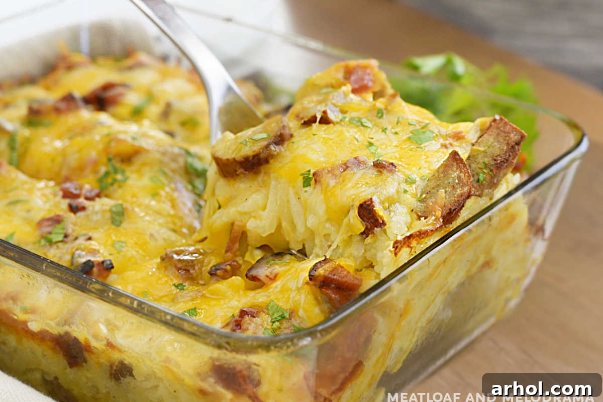 hashbrown breakfast casserole with sausage and cheese on a serving spoon
