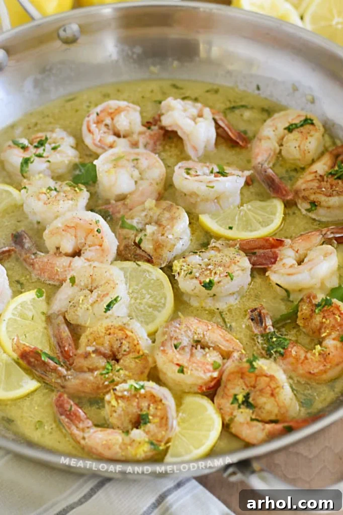 Perfectly cooked shrimp in a rich garlic butter sauce, garnished with lemon slices and fresh parsley