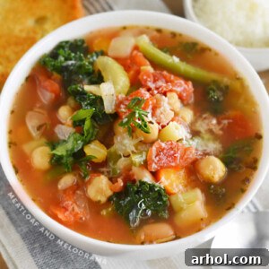 bowl of instant pot minestrone soup with garlic bread and parmesan cheese
