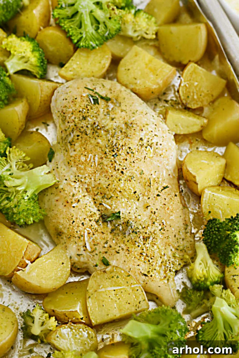 Effortless Ranch Chicken Sheet Pan 2 Baked ranch chicken and potatoes with broccoli and Parmesan cheese on sheet pan, a perfect one-pan dinner solution.