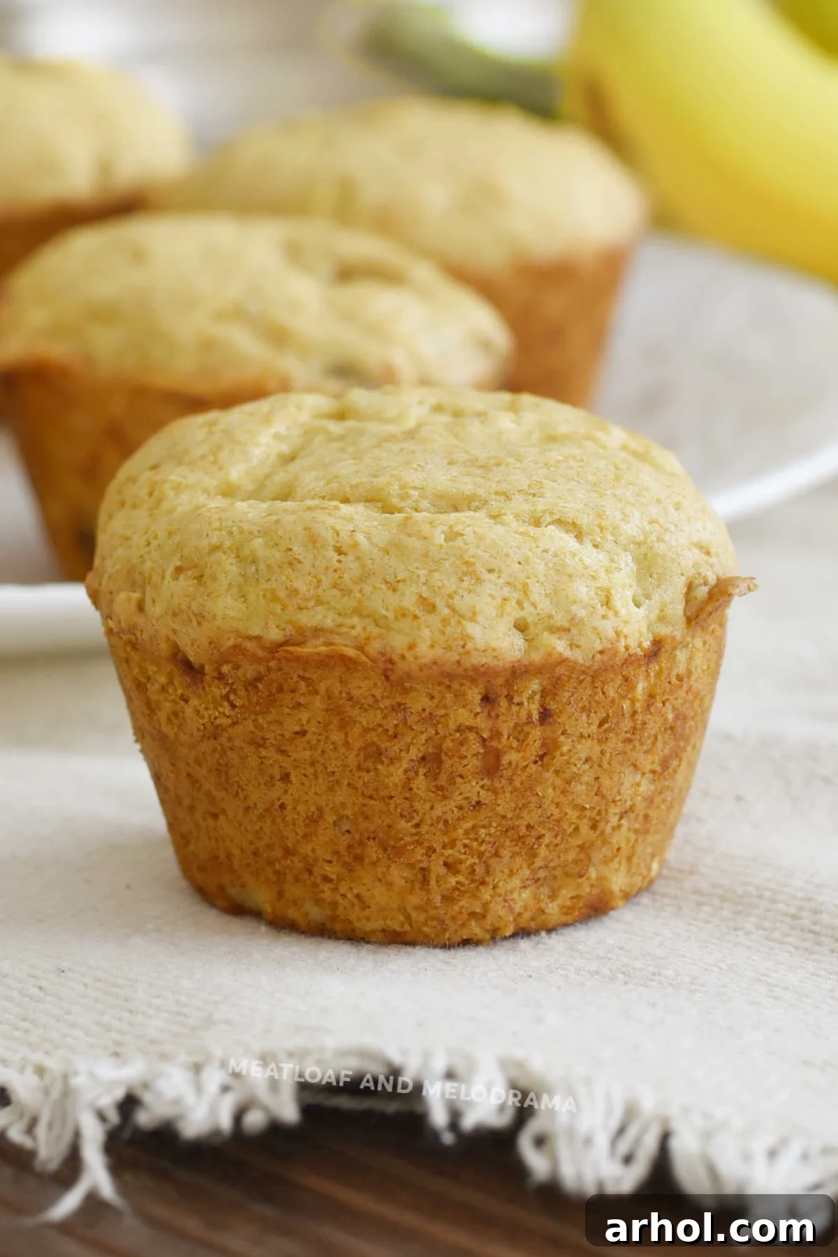 Golden brown banana muffins made with vanilla cake mix, fresh out of the oven