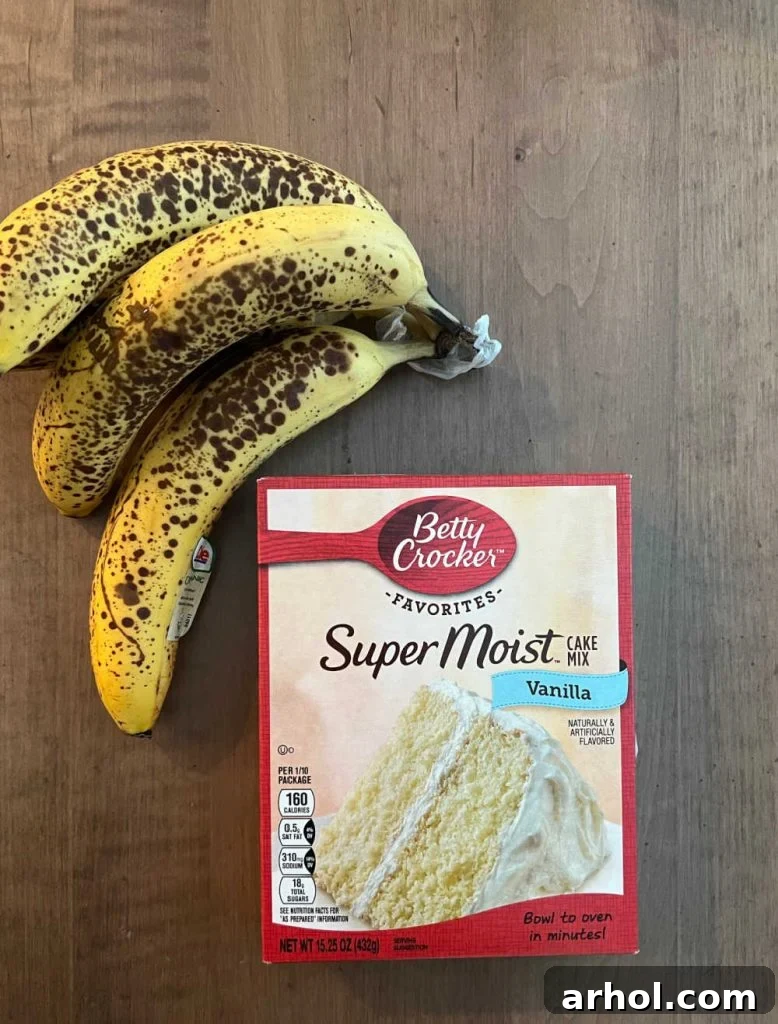 Box of Betty Crocker vanilla cake mix and ripe bananas on a kitchen table, ready for baking