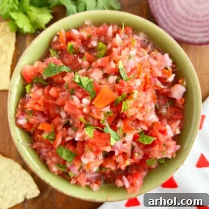 spicy pico de gallo recipe with red onion and cilantro in a green bowl