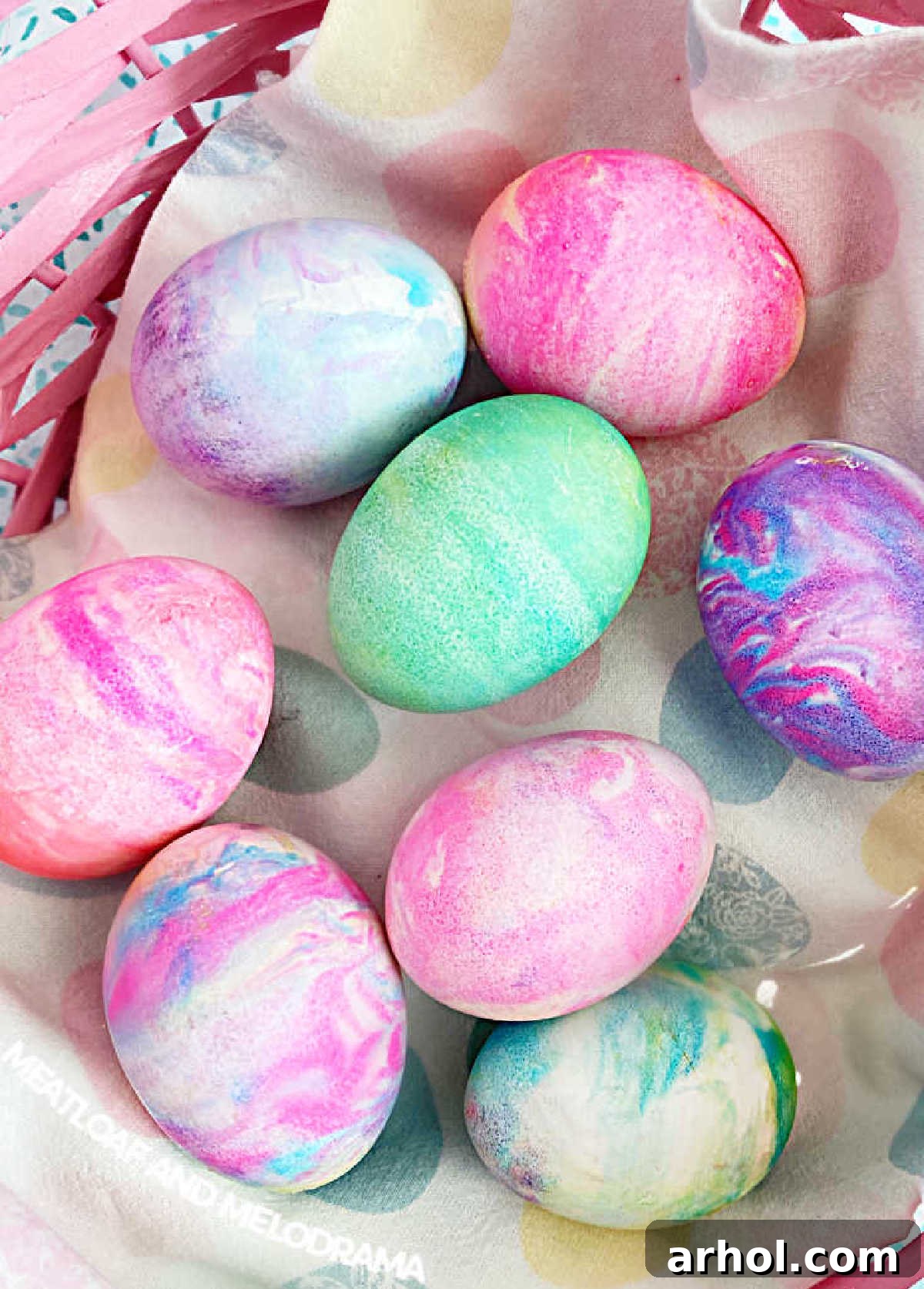 Finished Cool Whip Easter eggs, beautifully marbled and arranged in an Easter basket, ready for celebration.