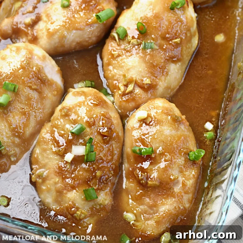 baked honey garlic chicken breasts with green onions in baking dish