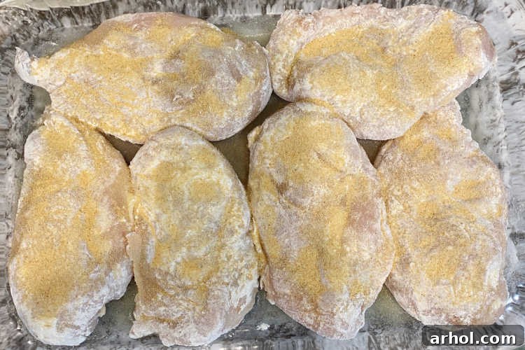 chicken breasts with flour and garlic in a baking dish
