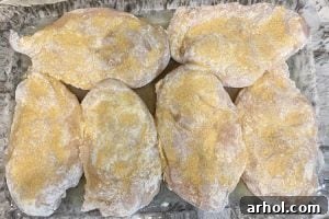 chicken breasts with garlic and flour in a baking dish