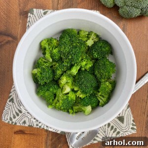 Bowl of microwave broccoli with serving spoon
