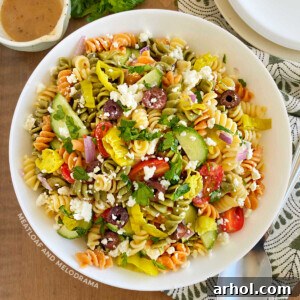 Greek pasta salad with feta cheese in white serving bowl