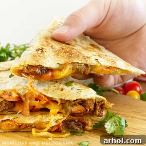 Sliced steak quesadilla with melted cheese in hand