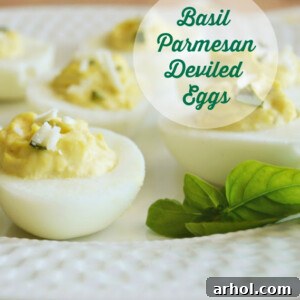 A plate of gourmet deviled eggs garnished with fresh basil and Parmesan