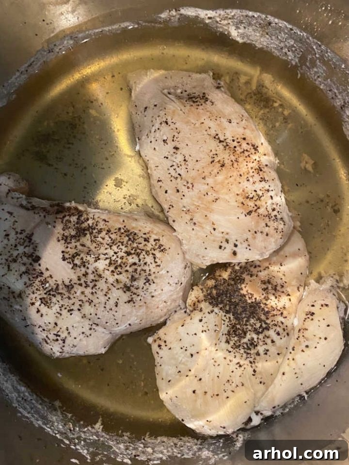 Cooked chicken breasts inside the Instant Pot after pressure cooking and release.