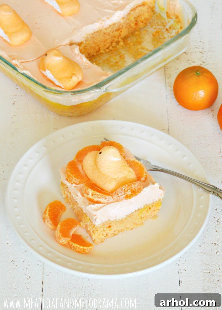 Orange Creamsicle Cake decorated with mandarin orange slices and orange Peeps