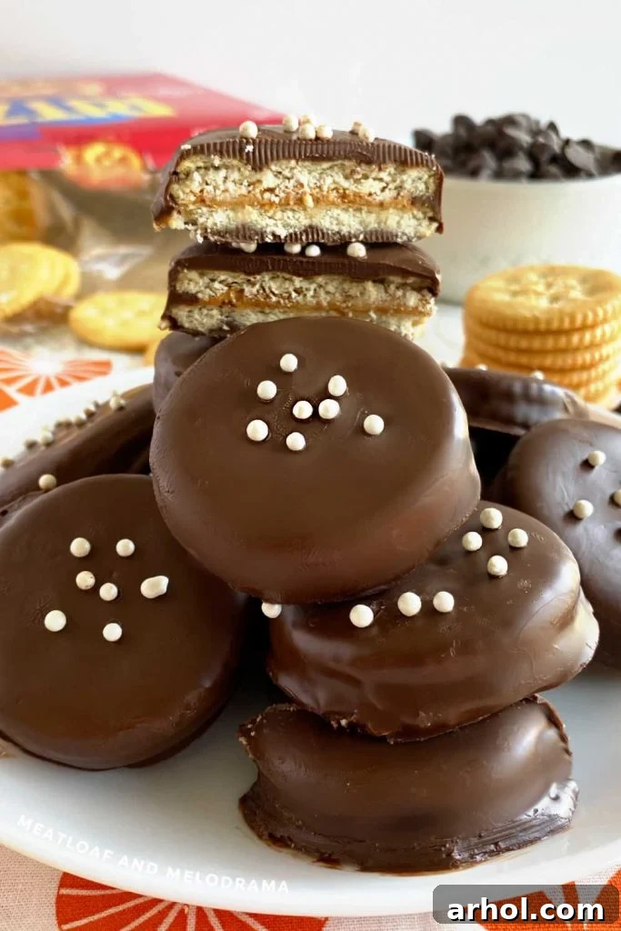 Delicious chocolate peanut butter Ritz cookies on a white plate, garnished with a few sprinkles, showcasing their tempting appeal.