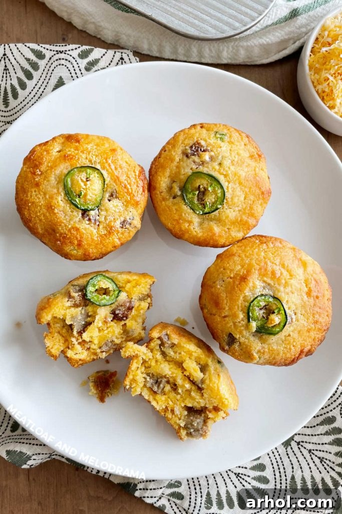 Plated Jalapeño Cheddar Corn Muffins with sausage, perfectly baked and ready to be enjoyed as a savory-sweet breakfast or side dish.