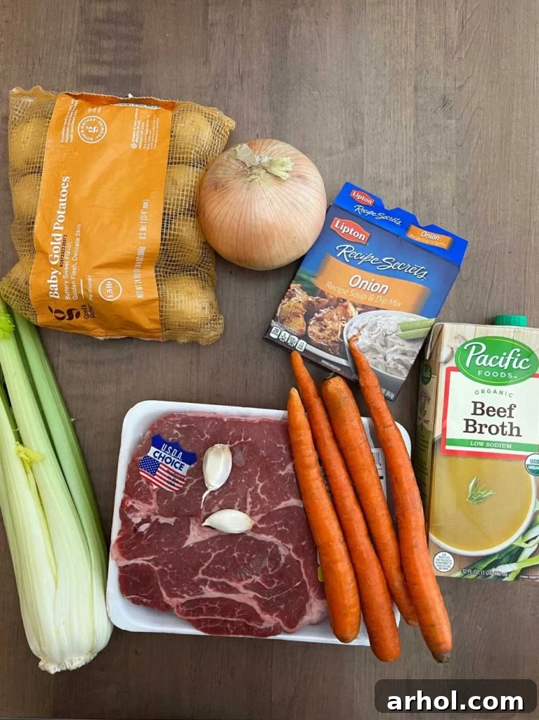 Ingredients for onion soup mix pot roast: beef chuck roast, baby potatoes, onion, onion soup mix, carrots, celery, garlic and beef broth.