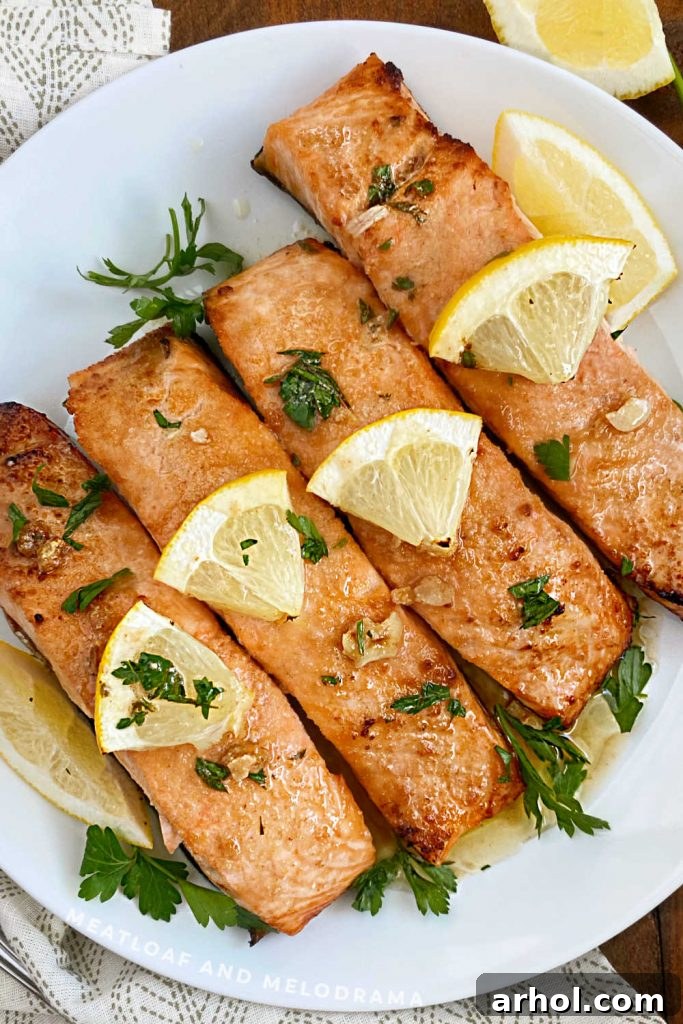 plate of lemon garlic butter salmon with lemon slices