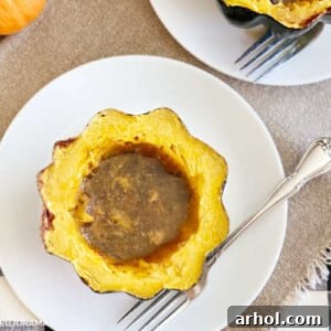 baked acorn squash with brown sugar and maple syrup on plate