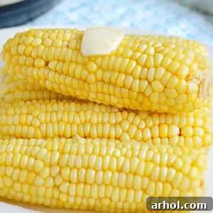 instant pot corn on the cob with butter on white platter.