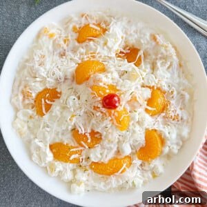 ambrosia fruit salad recipe with sour cream and mandarin oranges in white serving bowl
