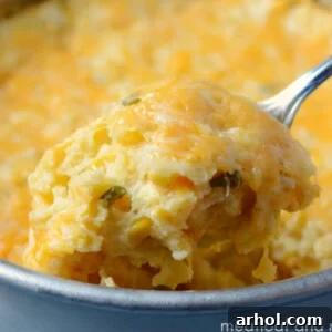 instant pot corn casserole with cheese on a spoon