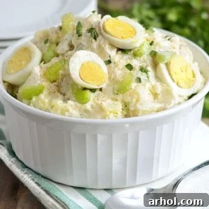 instant pot potato salad with red potatoes in a bowl with hard cooked eggs and celery