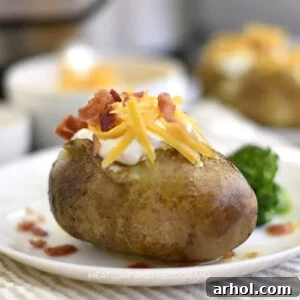 instant pot baked potatoes with sour cream cheddar cheese and bacon on a plate