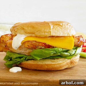 Ninja Foodi Grilled Buffalo Chicken Sandwich with American cheese, ranch dressing and lettuce on a bun