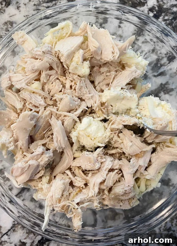 mix rotisserie chicken and ricotta cheese in mixing bowl