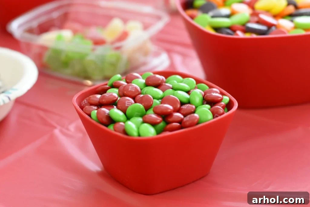 Bowl of red and green M&Ms on a table at a gingerbread house party