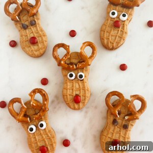 nutter butter reindeer cookies with pretzel antlers on marble cake stand