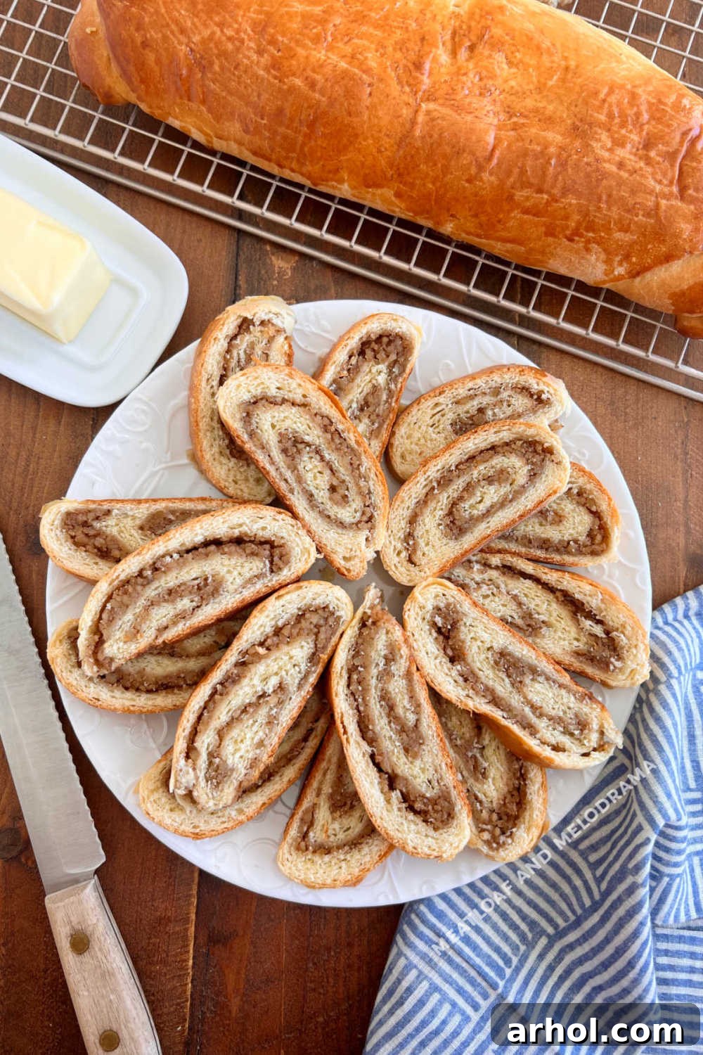 Pittsburgh style Slovak nut roll slices on a platter with loaf in background