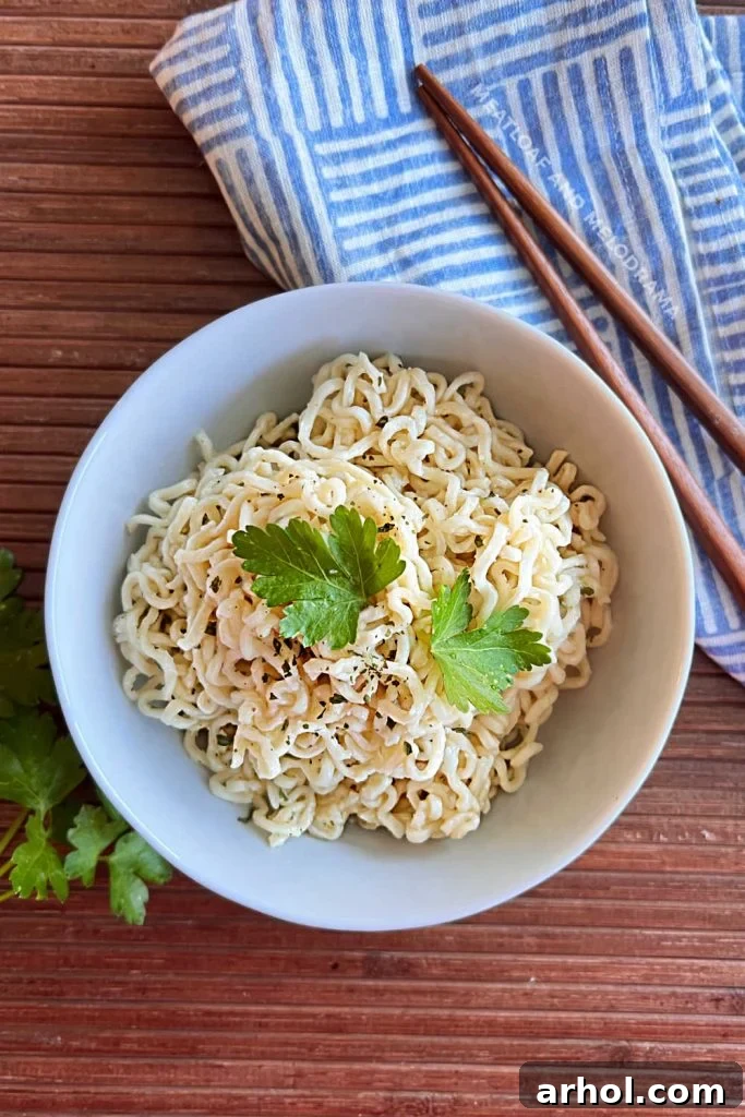 bowl of cooked ramen noodles with parsley on the table